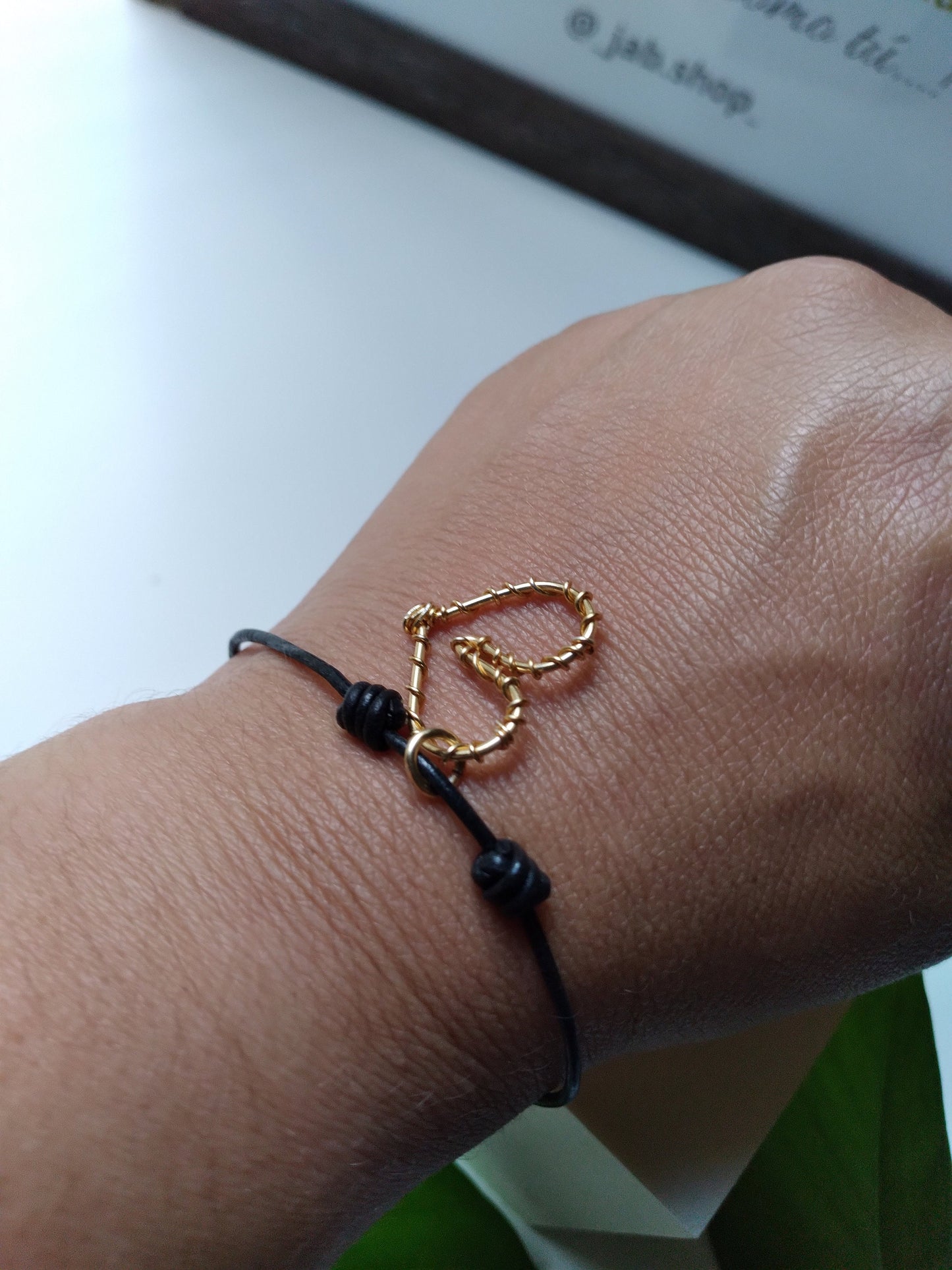 Black leather bracelet with heart pendant.