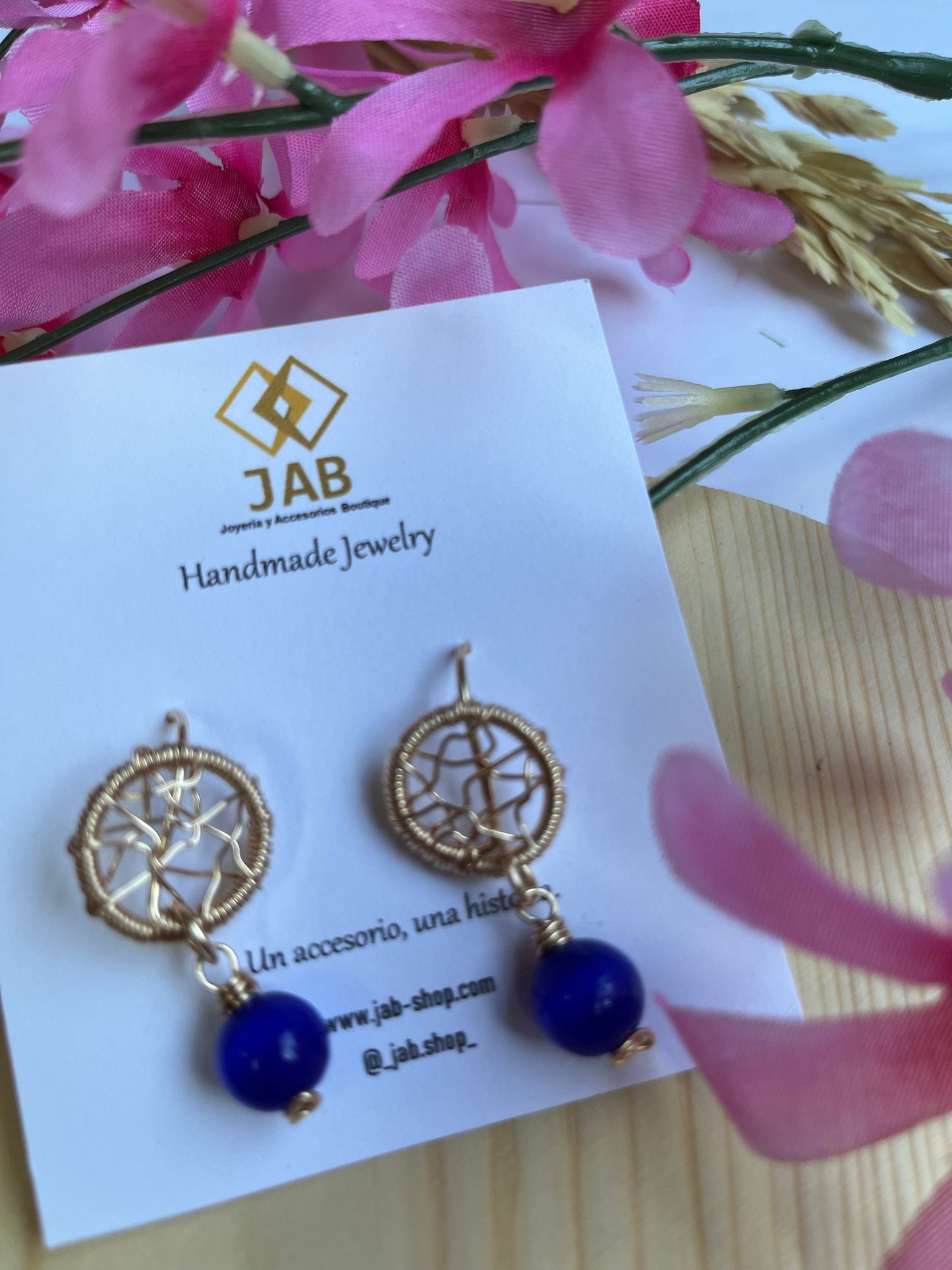 Dreamcatcher earrings with blue glass crystal.