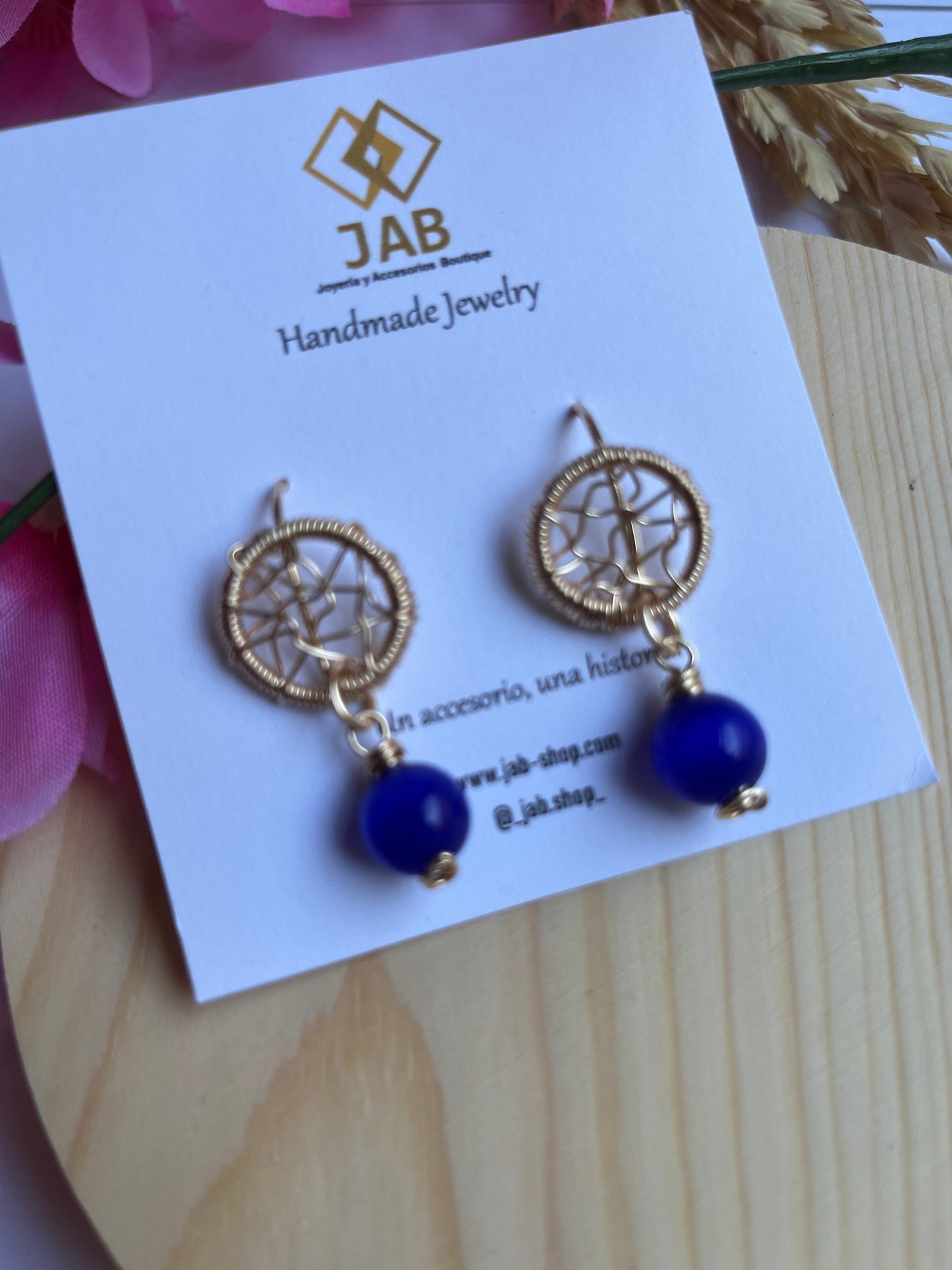 Dreamcatcher earrings with blue glass crystal.